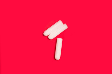 hygienic tampons on a red background, womens health