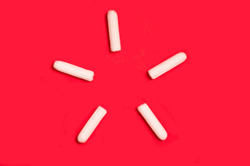  star shape made of tampons on a red background