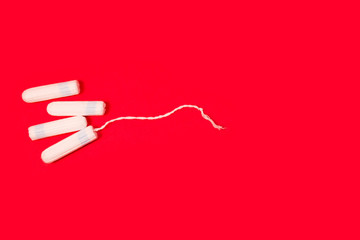 hygienic tampons on a red background, womens health