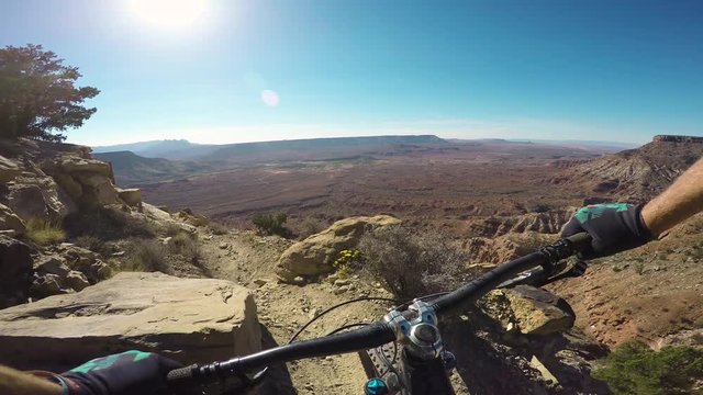 Professional Cyclist Riding Trail In The Desert