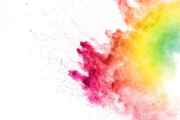 Freeze motion of colorful color powder exploding on white background.  Paint Holi.