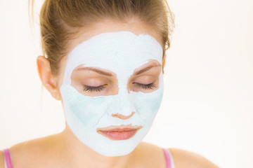 Girl with green mud mask on face