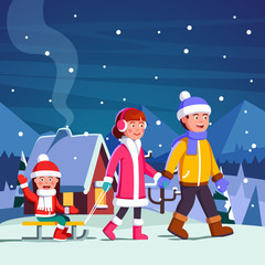 Fototapeta premium Family couple with child on sled walking in winter