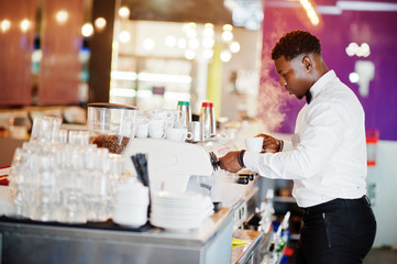 Fototapeta na wymiar African american bartender barista at bar preparing coffee.