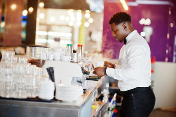 Fototapeta na wymiar African american bartender barista at bar preparing coffee.