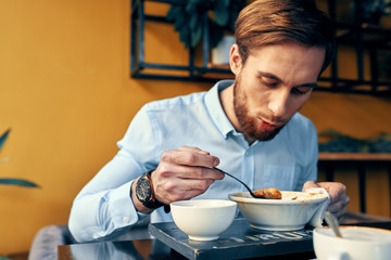 man eating breakfast in bed