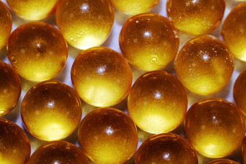 yellow orang omega 3 capsules on white  background