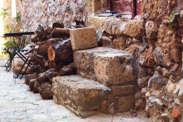 Stacked firewood near the doorstep of the house in the medieval tourist town of Monemvasia.