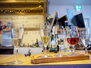 Wide closeup of multiple glasses of fine wines during a tasting session. Penzace, Cornwall, England. Travel and Cornish wine industry.