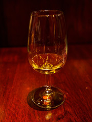 Closeup of a glass of whisky on a wooden mahogany table, traditional British Pub. Tokyo, Japan. Travel and drinks.
