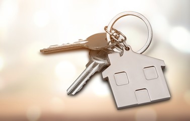 House keys with house figure  on background