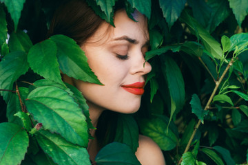 woman in park green leaves