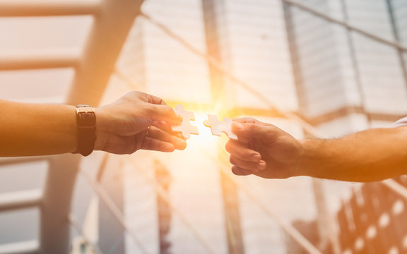 Teamwork,partnership and Social connection in business concept.Hand of diverse people connecting jigsaw puzzle. - Powered by Adobe
