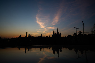 Kremlin silhouette view at sunset in Moscow, Russia. Dormition orthodox cathedral in the middle with other bell towers and towers on the sides. Architecture and travel concepts