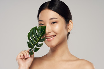 Beautiful woman with palm leaf