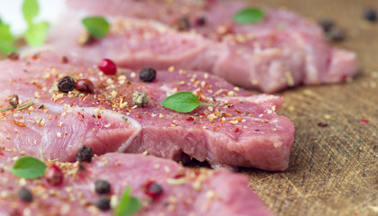 Steaks sprinkled with spices and herbs. Juicy steaks for a barbecue close up.