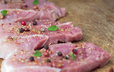 Steaks sprinkled with spices and herbs. Juicy steaks for a barbecue close up.