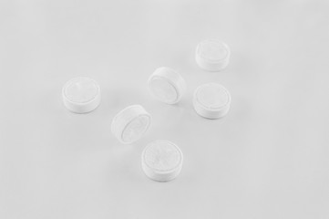 Compressed, dry, biodegradable coin tissues on a white background. Tablet tissues in practical and compact pill form.
