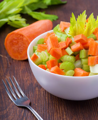 Fresh salad from stalks of celery, carrots, apples and cheese. Fitness breakfast, healthy.