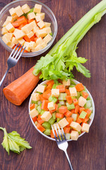 Fresh salad from stalks of celery, carrots, apples and cheese. Fitness breakfast, healthy.
