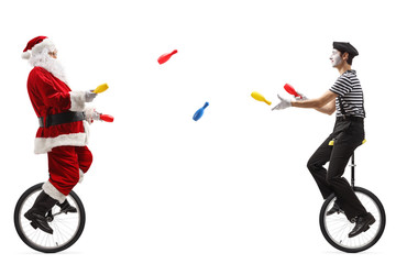 Santa claus and a mime on unicycles juggling with clubs © Ljupco Smokovski