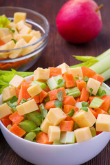 Fresh salad from stalks of celery, carrots, apples and cheese. Fitness breakfast, healthy.