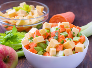 Fresh salad from stalks of celery, carrots, apples and cheese. Fitness breakfast, healthy.