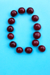 Letter Q fresh cherry alphabet blue color flat lay