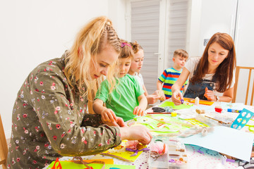 Children with mothers making greeting cards for the holiday