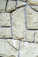 The vertical wall is faced with a rough, rough chopped stone. Natural background for designers.
