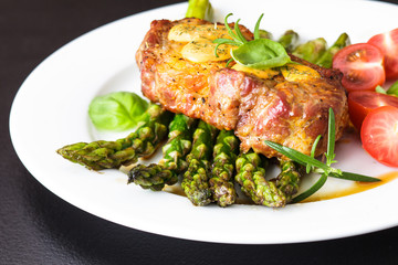 Gourmet steak with green asparagus on the plate
