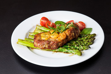 Gourmet steak with green asparagus on the plate
