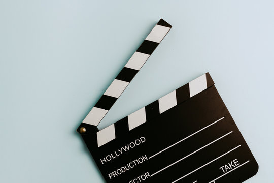 A Clapboard in a pastel turquoise background