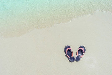 Flip flops on Tien Beach at Koh Larn Island in Thailand.