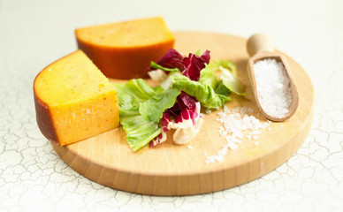 Fresh lettuce, cheese, ham and sea salt on a cutting board. Intercontinental breakfast at the hotel.