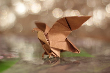 origami eagle on bokeh background