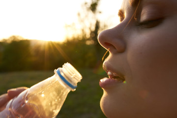 young woman drinking water from a bottle