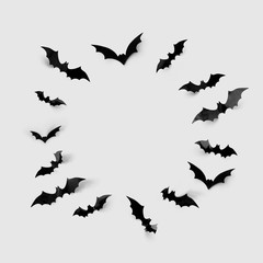 halloween decorations concept - black paper bats in circle on grey background