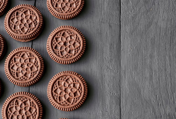 Chocolate flavored cookies on a dark wooden background.