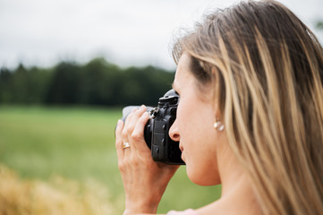 Young female photographer taking photos