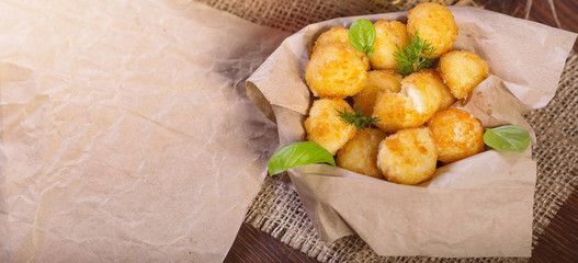 Cheese snacks for beer. Cheese balls with basil leaves.
