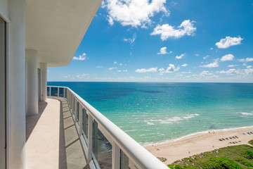 View from a condominium balcony showing the beach and ocean