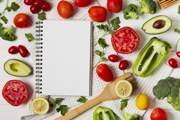 Flat lay arrangement with vegetables and notebook