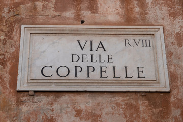 Fototapeta premium Street sign on marble plate: via delle Coppelle, Rome, Italy