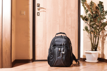 Backpack near the door in the hallway