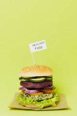 Tasty vegan burger with healthy food sign