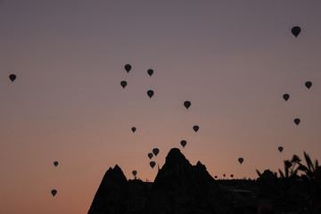 silhouettes of hot air balloons in the sky at sunrise