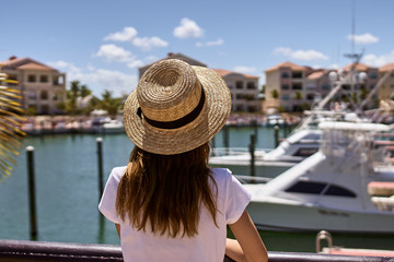 woman in hat on balcony