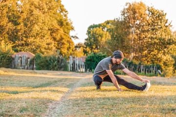 Sports and yoga. A man with a beard, in sportswear doing sports in the Park. Copy space