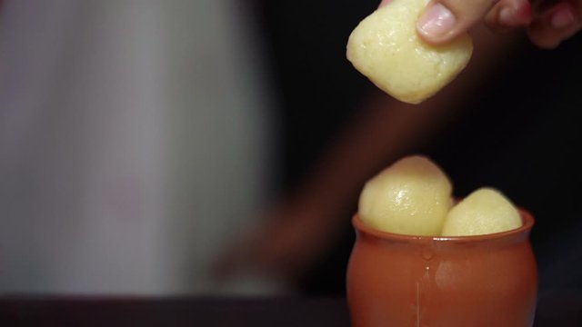 Rasgulla For Durga Puja Vijaya Dashami, Dussehra. An Indian sweet also known as Rosogolla, Roshogolla, Ras Gulla, continuously dripping syrupy dessert popular in Kolkata, India, Bangladesh.